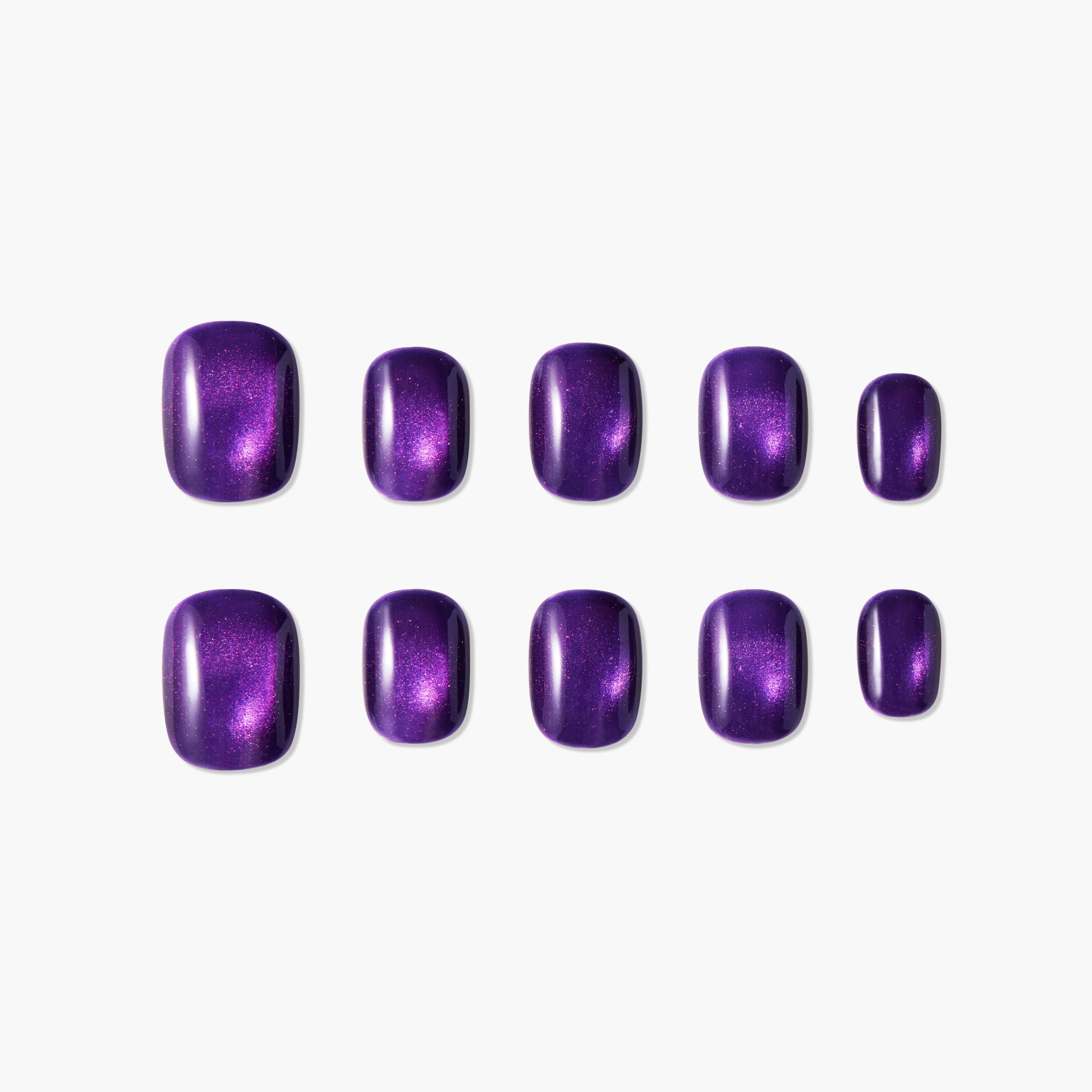 Set of glossy purple press-on nails with shimmering effect on white background