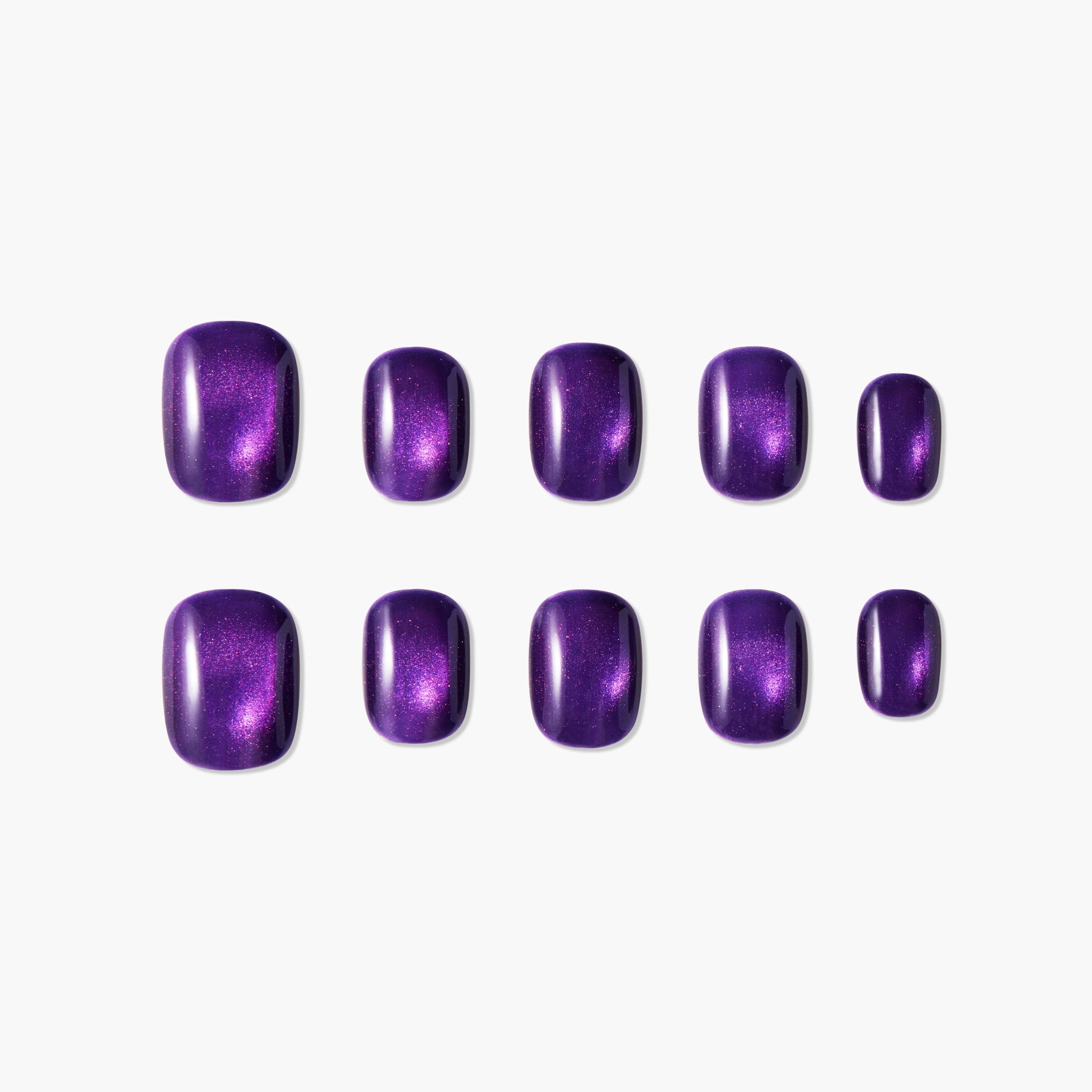 Set of glossy purple press-on nails with shimmering effect on white background