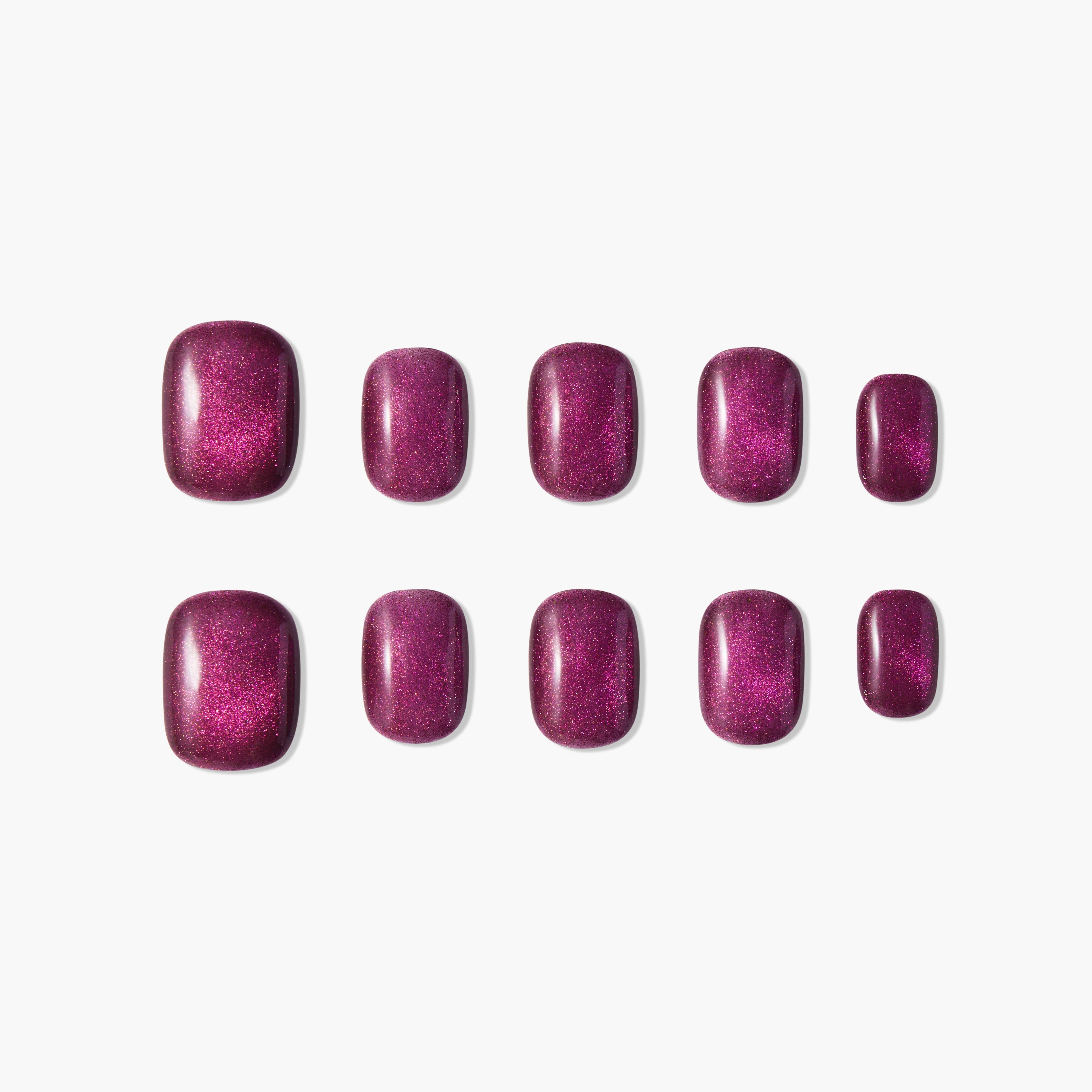 Set of glossy, deep magenta press-on nails with shimmer, displayed on white background