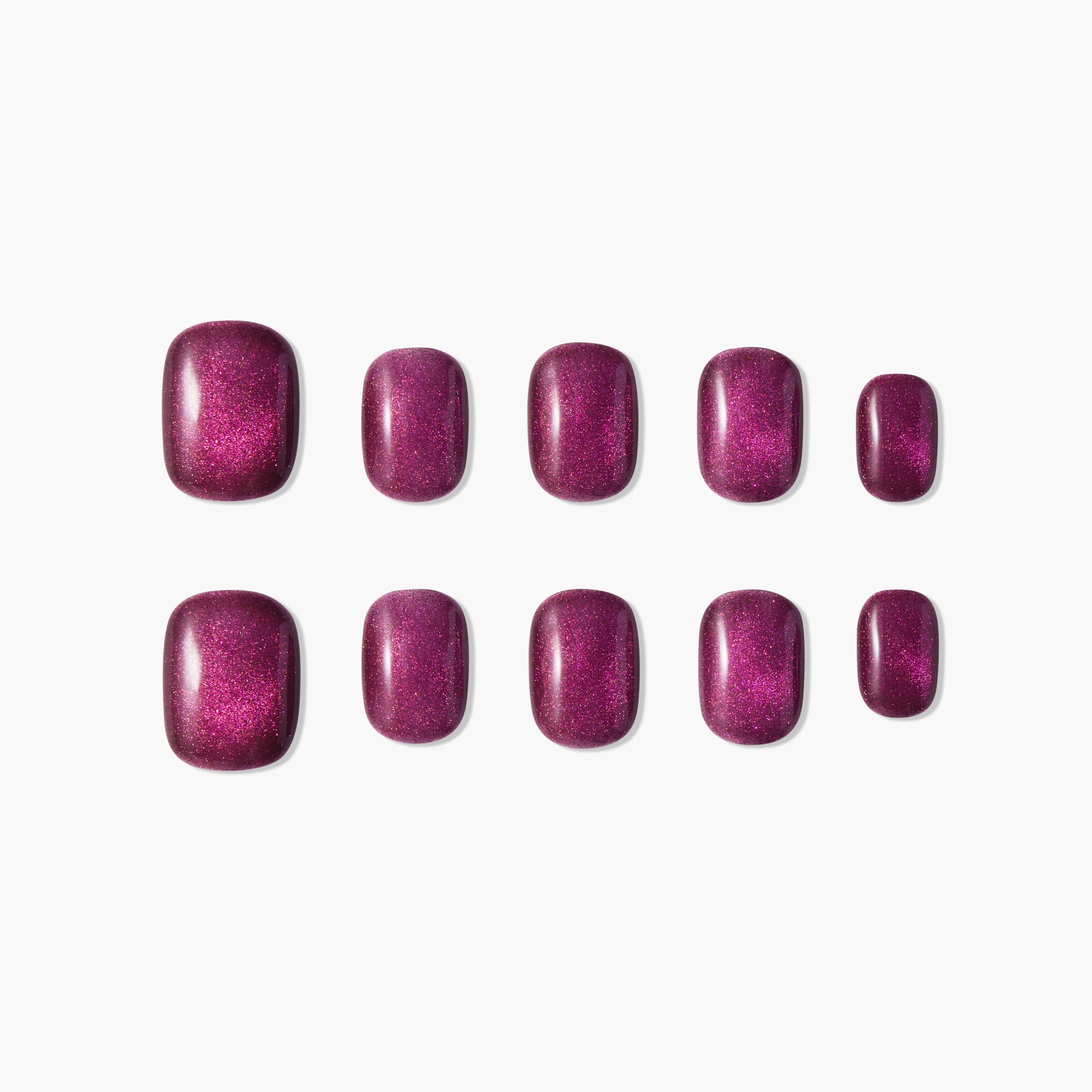 Set of glossy, deep magenta press-on nails with shimmer, displayed on white background