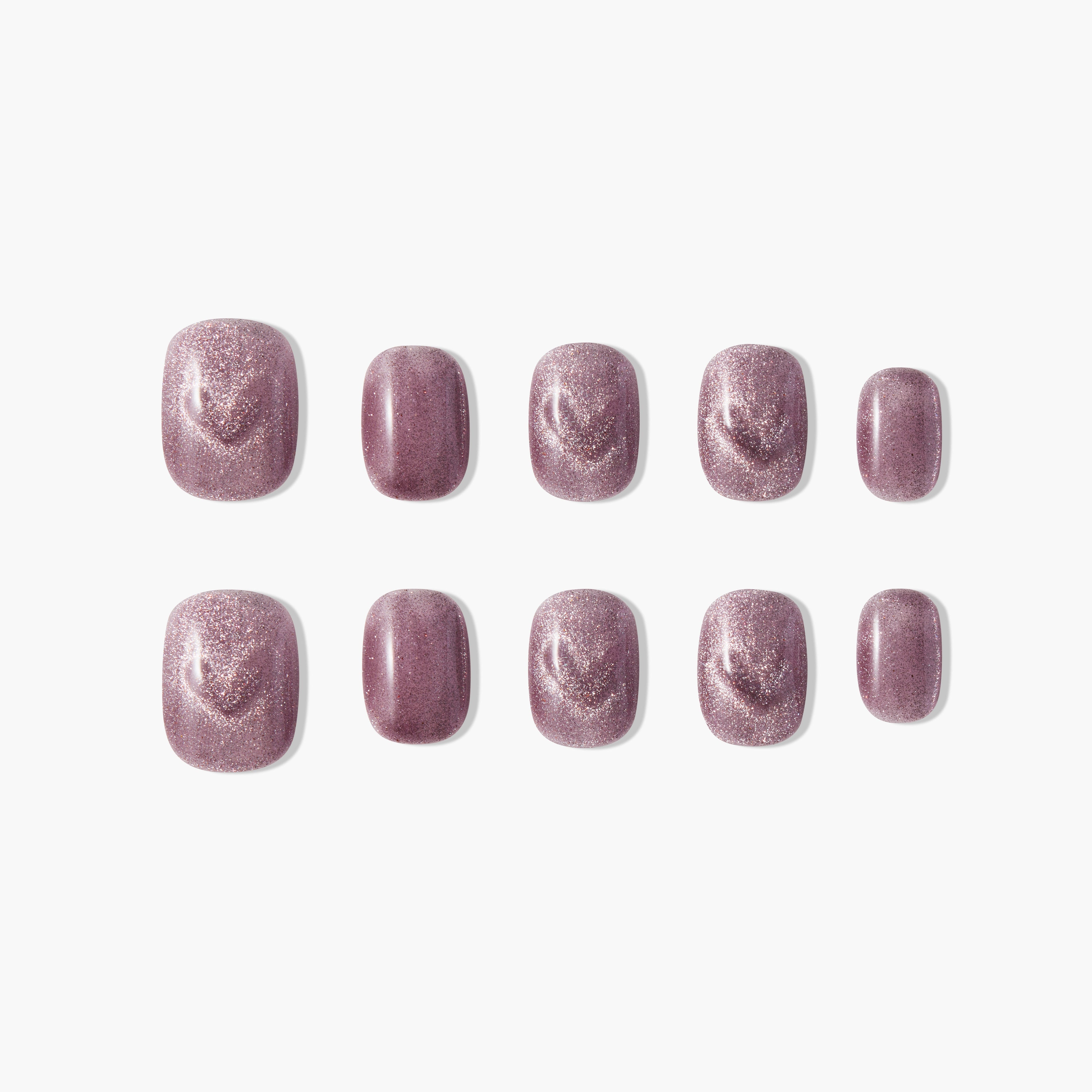 Short square press-on nails with shimmery mauve purple finish, arranged on white background.