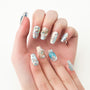 Hand with mermaid-themed press-on nails featuring blue, pearl, and sequin 3D accents
