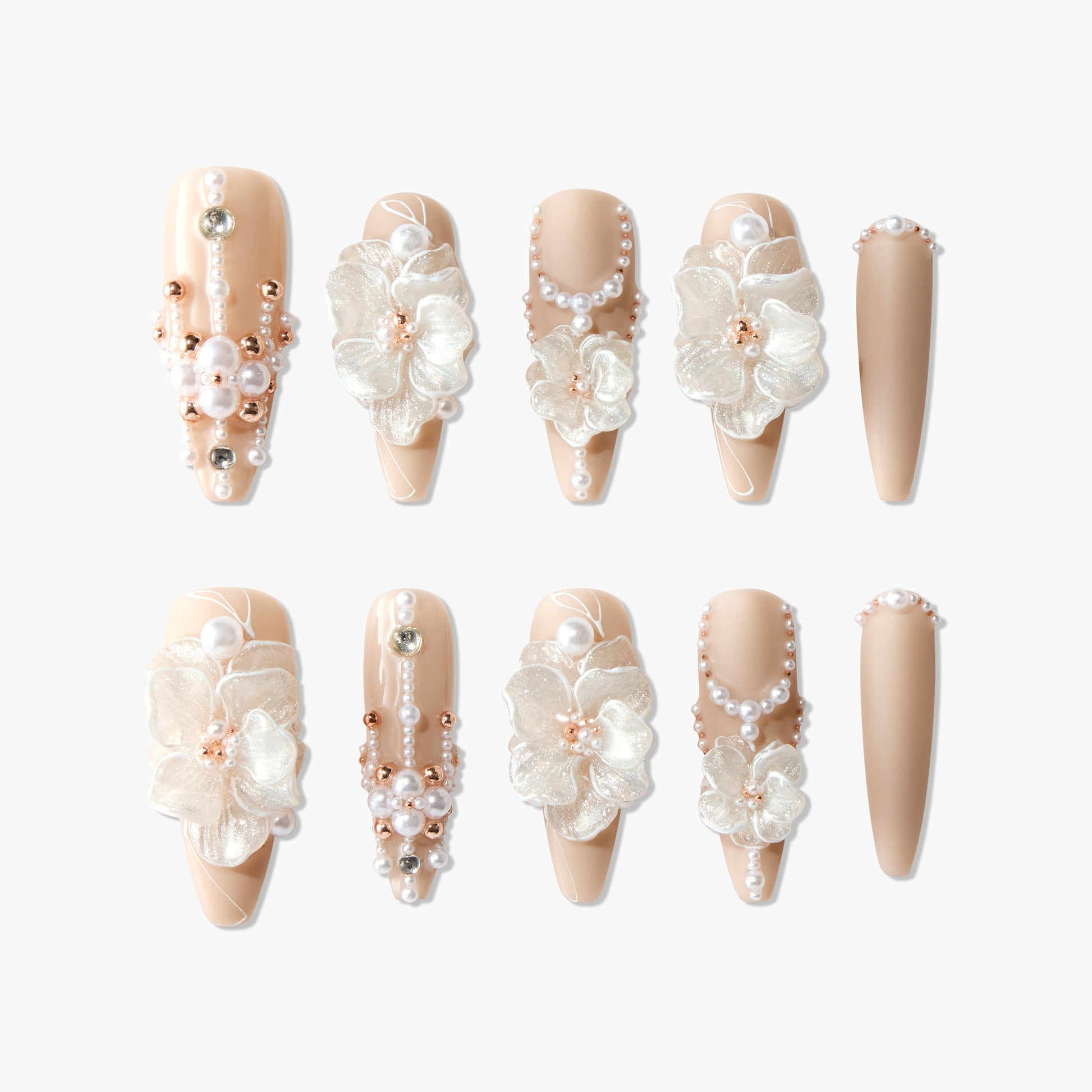 Handmade nude press-on nails with 3D white flowers, pearl and gold bead accents, elegant nail art