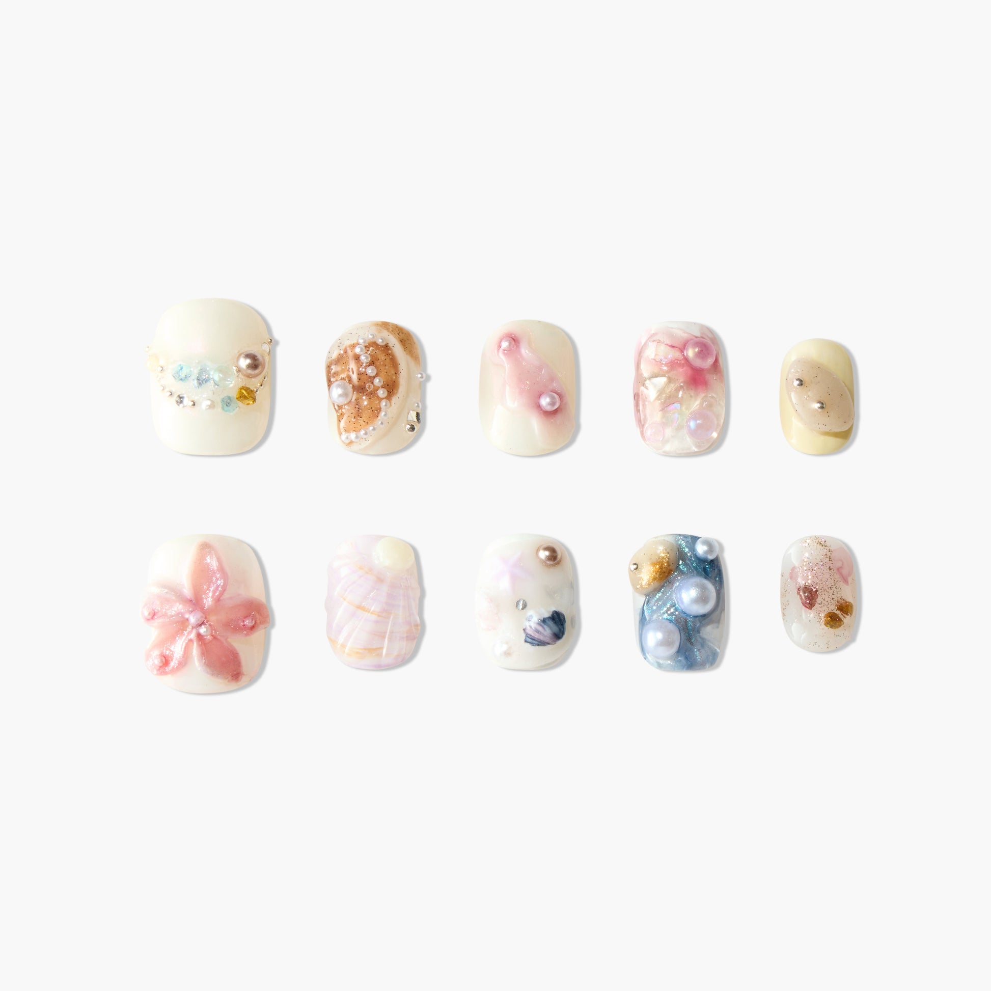 Handmade beach-themed press-on nails with seashell, starfish, and pearl accents, pastel colors