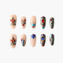 Handmade press-on nails with intricate red, blue, and gold floral designs on nude base.