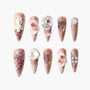 Handmade press-on nails with pink base, 3D rose designs, pearls, and gold embellishments