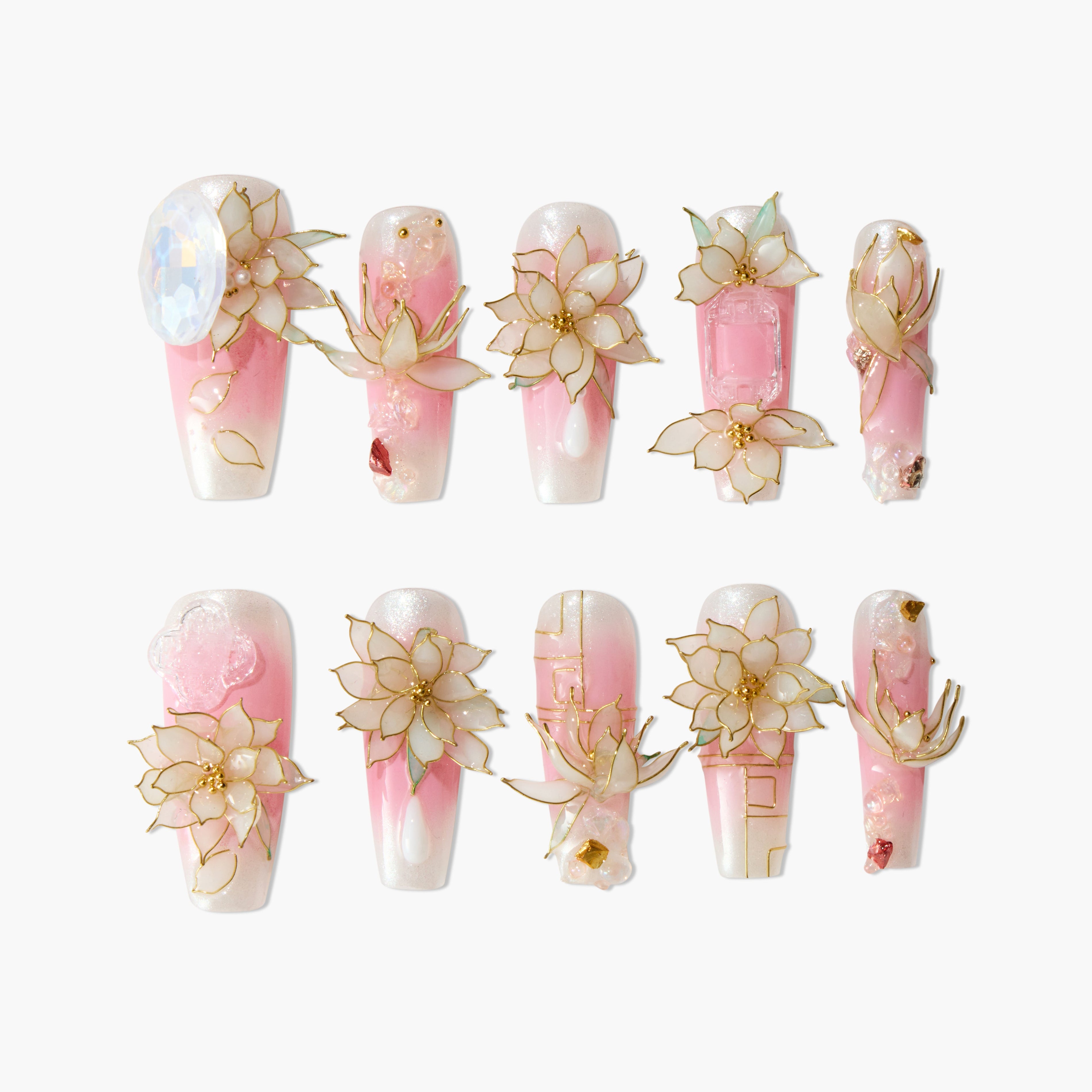 Handmade press-on nails with pink and white ombre, 3D floral designs, and gold accents