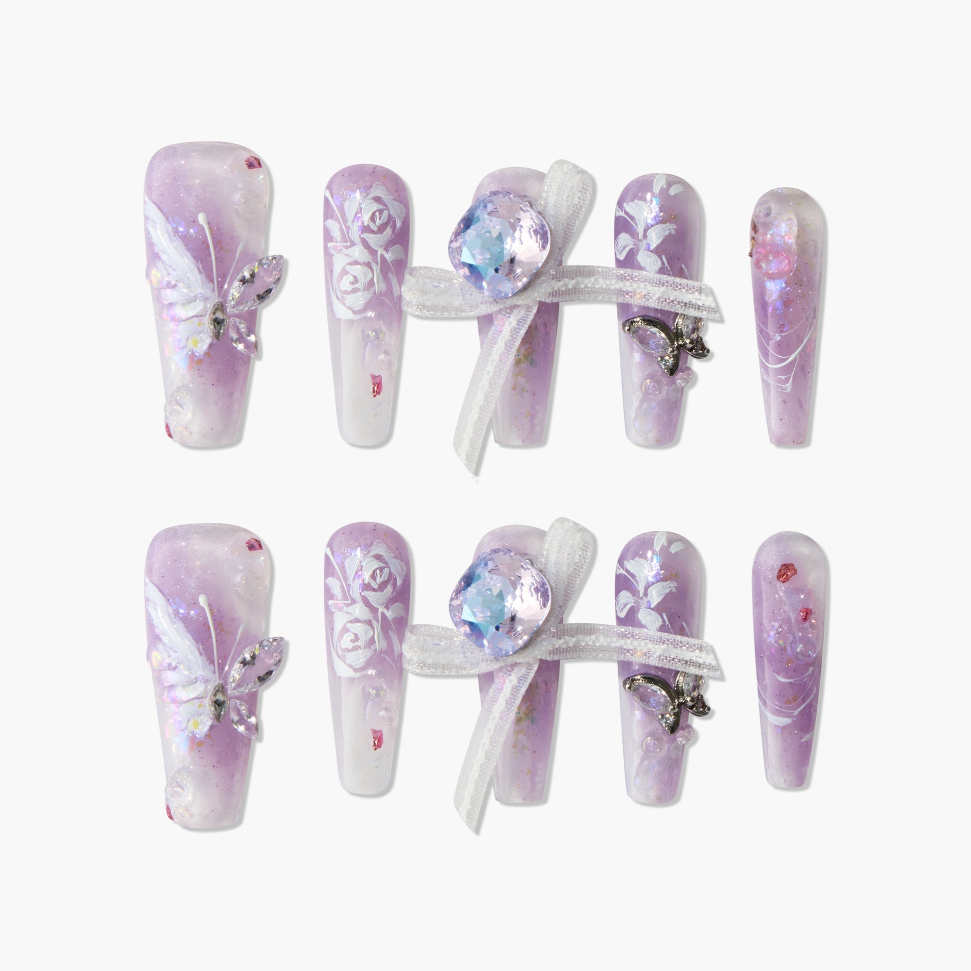 Handmade lavender press-on nails with butterfly, bows, floral design, and gemstone accents.