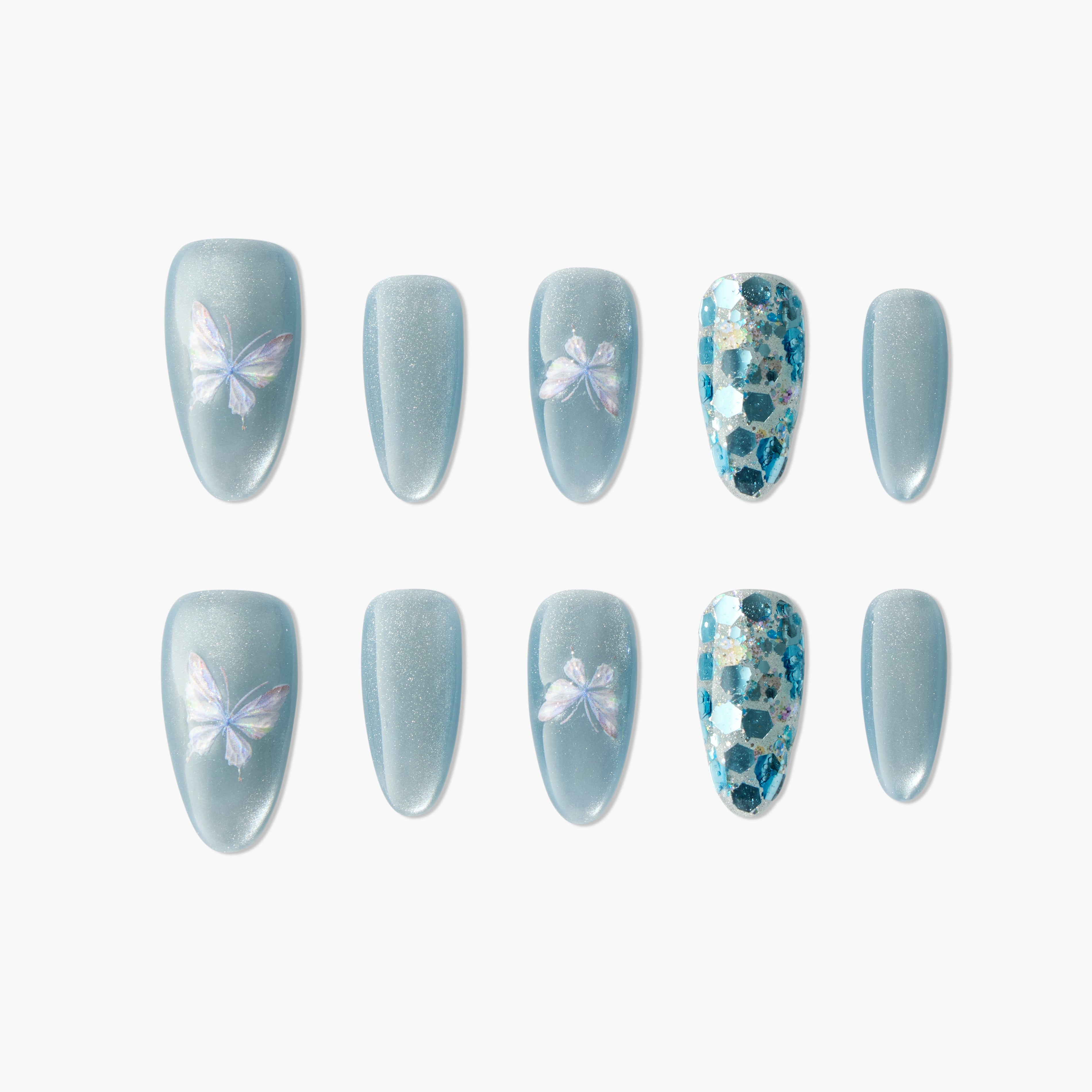 Blue press-on nails with iridescent butterfly designs and blue glitter accents, arranged on white background.