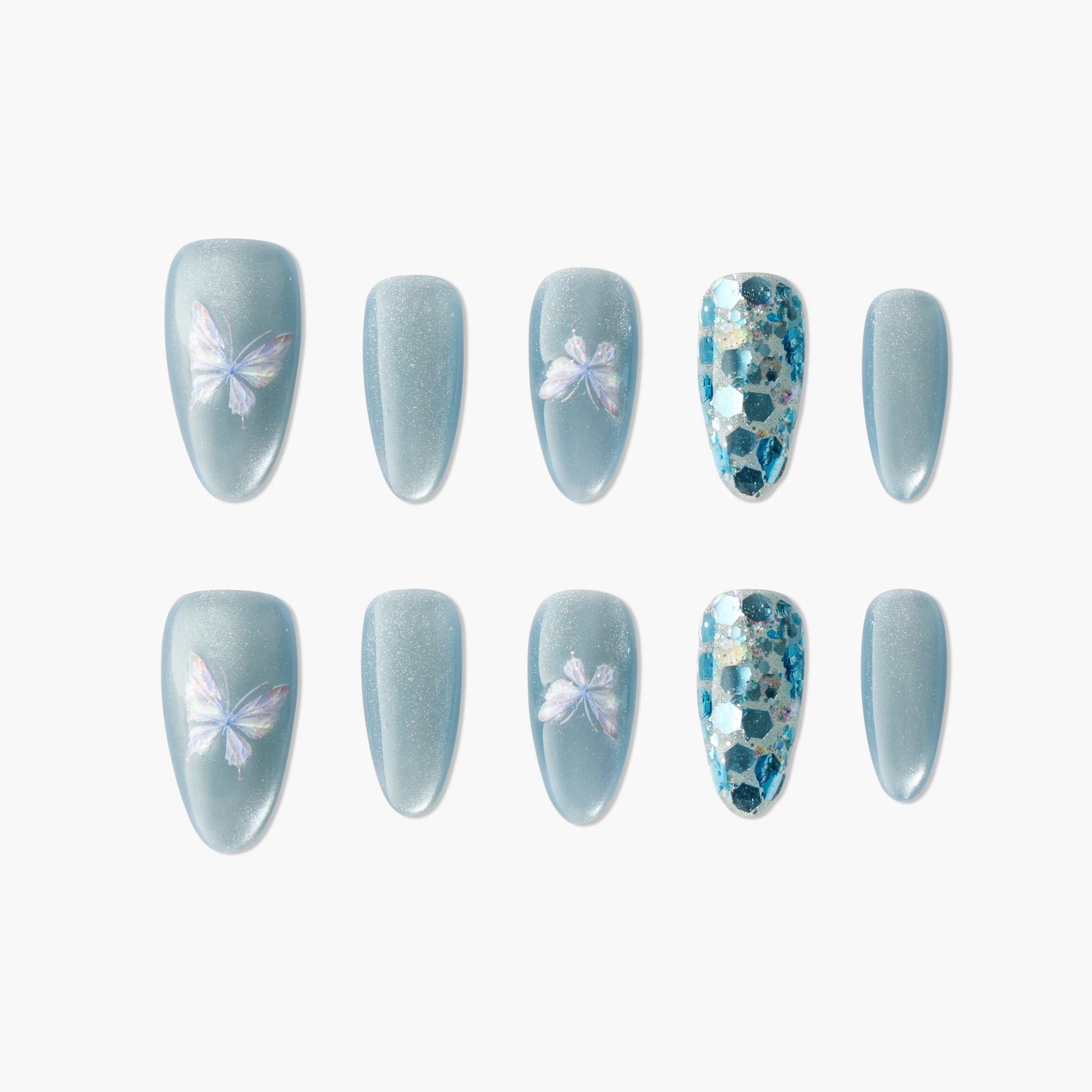 Blue press-on nails with iridescent butterfly designs and blue glitter accents, arranged on white background.