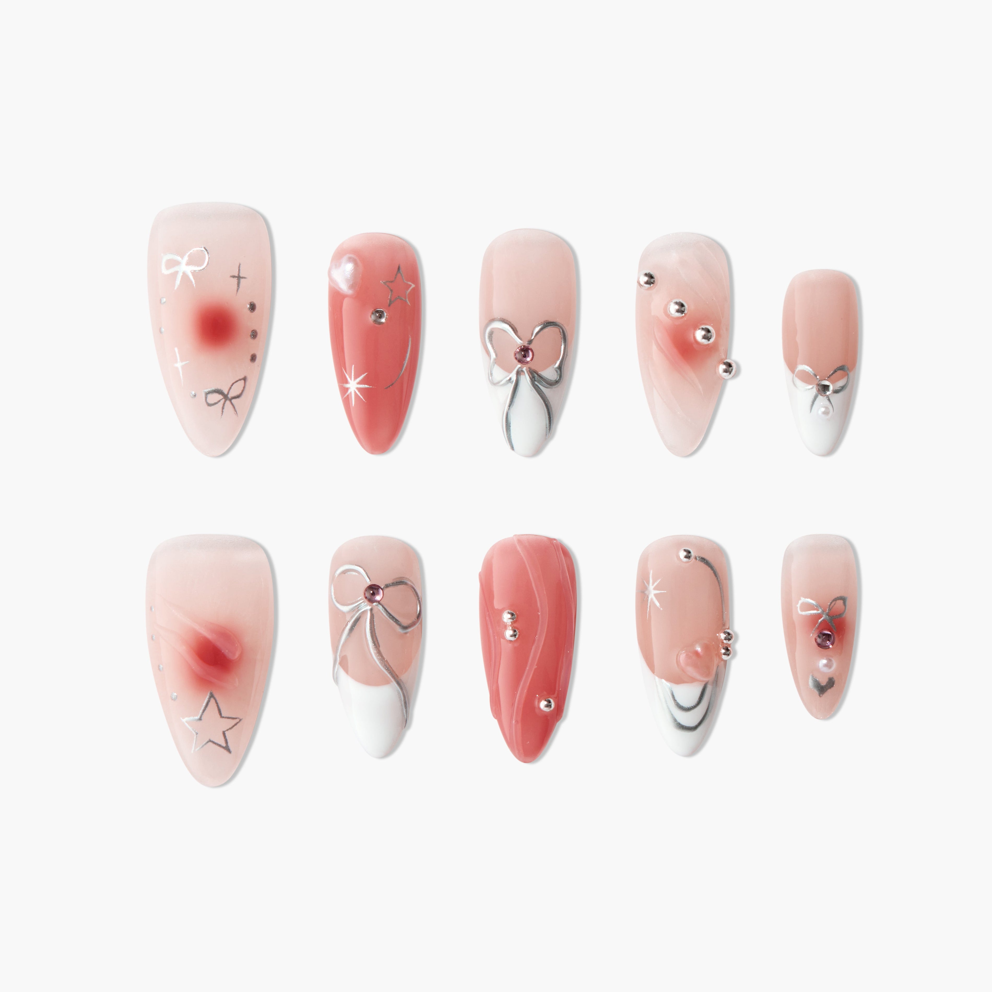 Handmade pink press-on nails with silver bows, gems, stars, and marbled designs