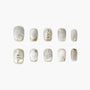 Silver press-on nails with Christmas tree and snowflake designs, festive nail art set