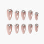 Set of pink almond-shaped press-on nails with heart-shaped rhinestone accents