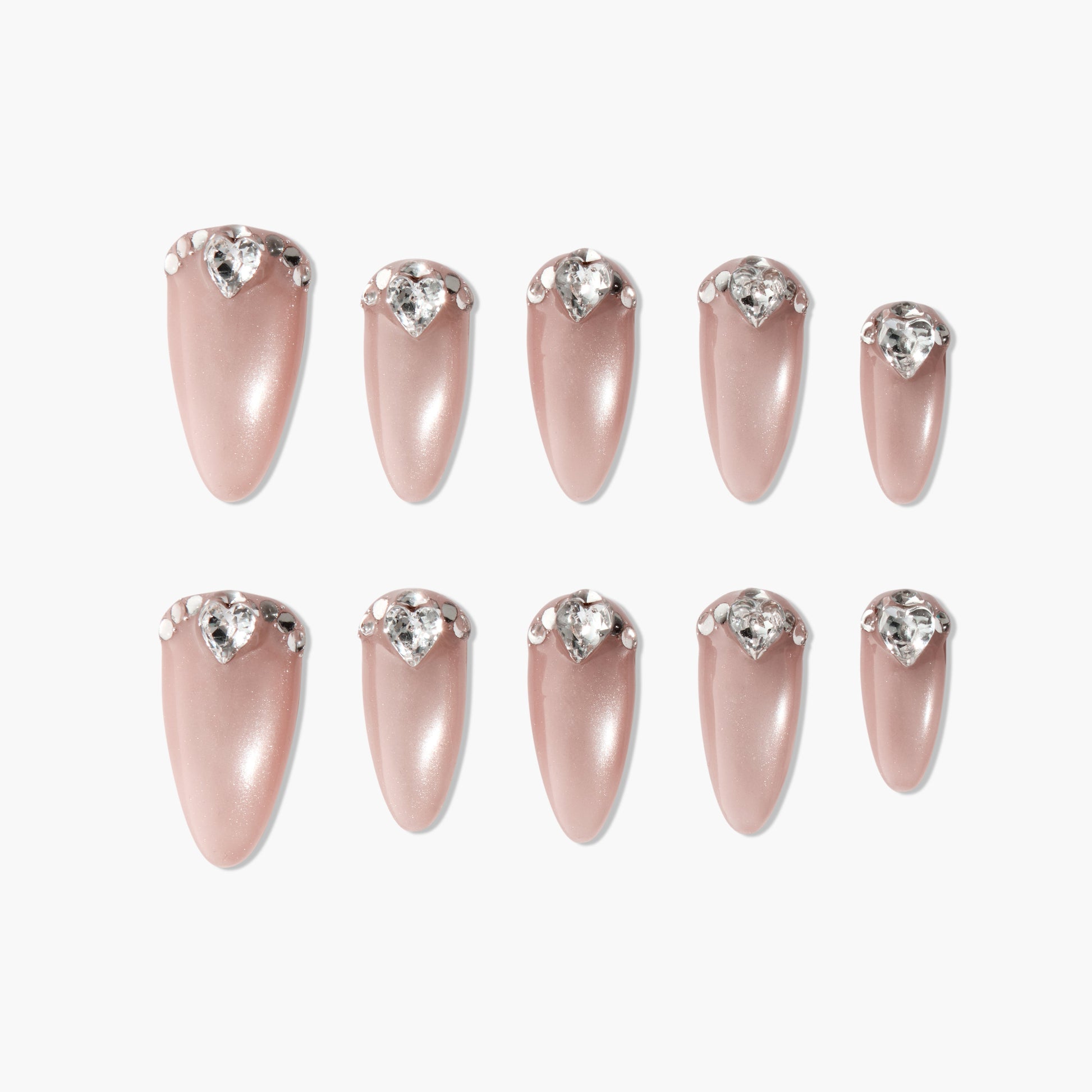 Set of pink almond-shaped press-on nails with heart-shaped rhinestone accents