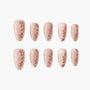 Handmade press-on nails with pink floral design and green leaves on a nude base