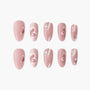 Pink press-on nails with 3D hearts and butterfly accents, glossy salon-quality finish