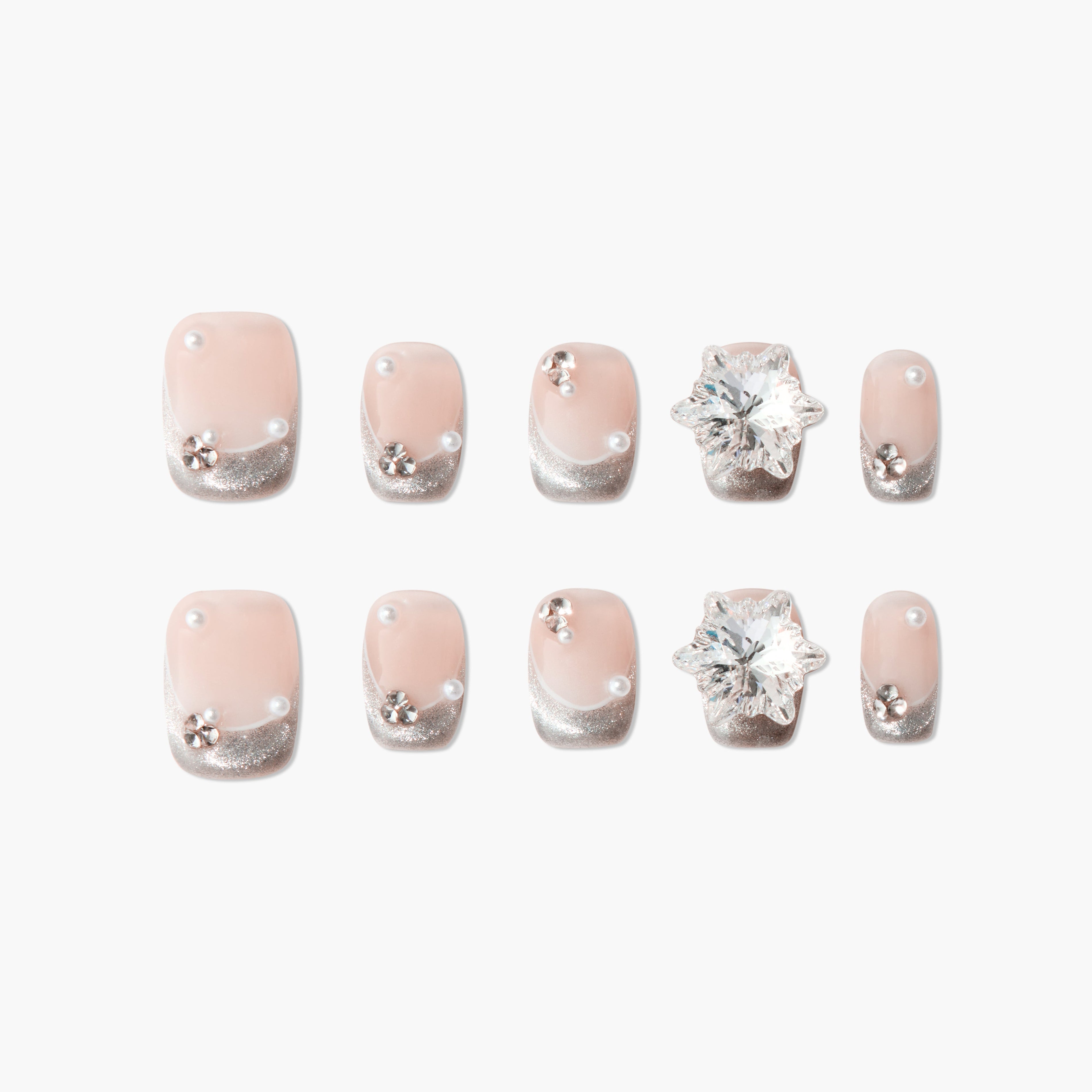 Handmade press-on nails with pink base, silver glitter tips, pearls, and floral rhinestones