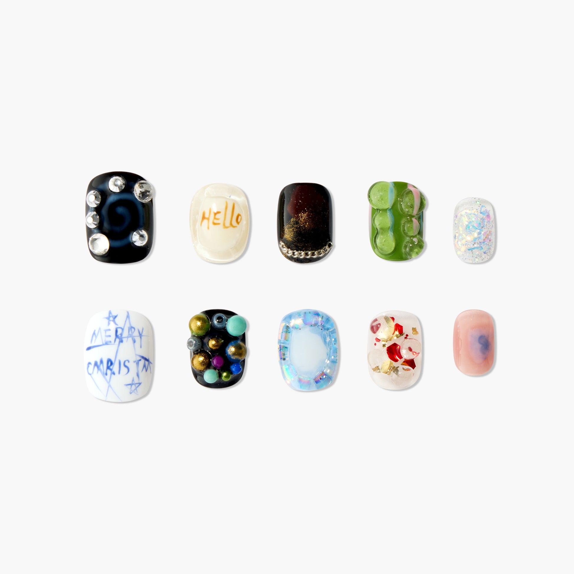 Assorted handmade press-on nails with unique colorful designs, gems, and festive patterns.