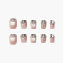 Set of glossy pink press-on nails with diamond-shaped rhinestone accents, elegant design
