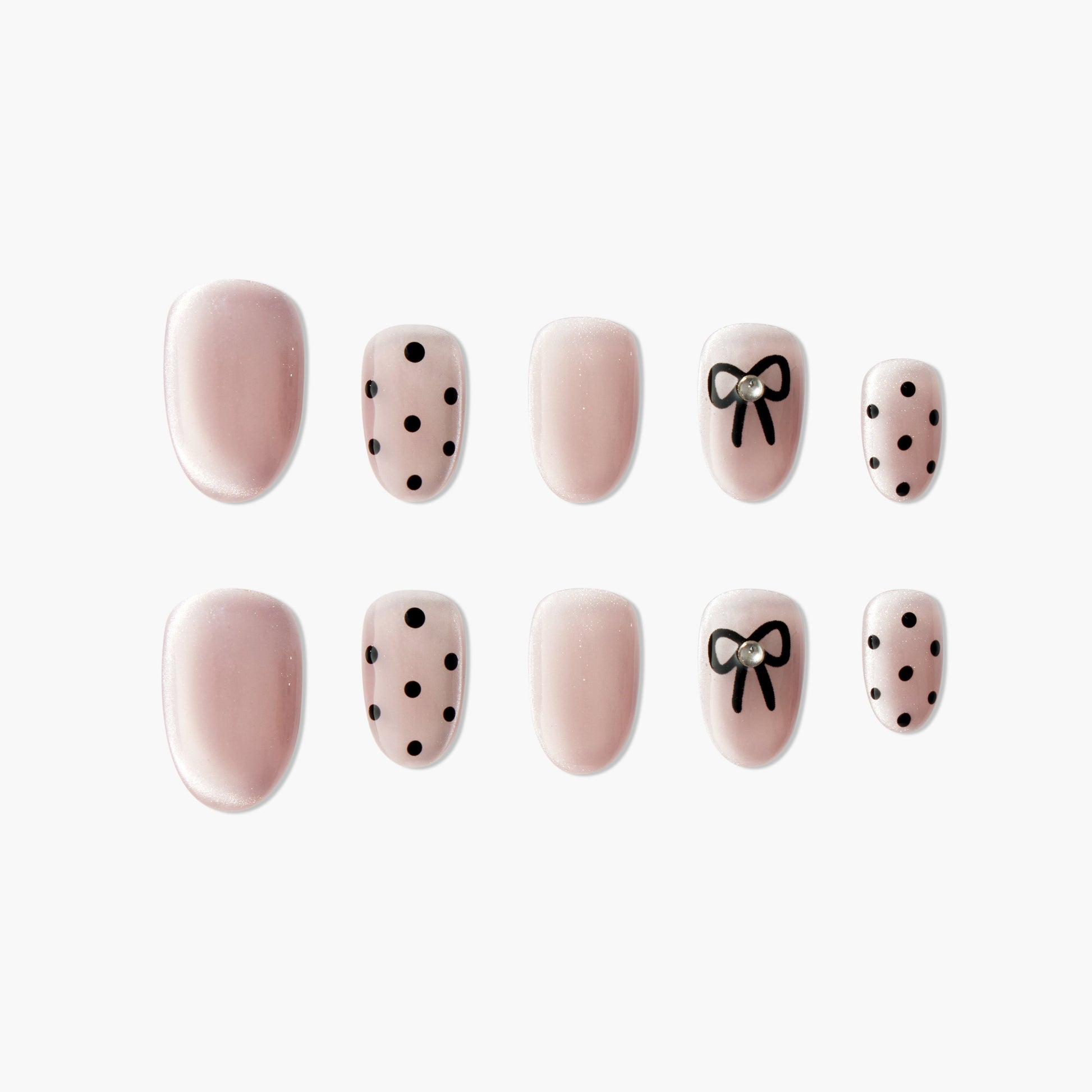Pink press-on nails with black polka dots and bow design, pearl accent, glossy finish