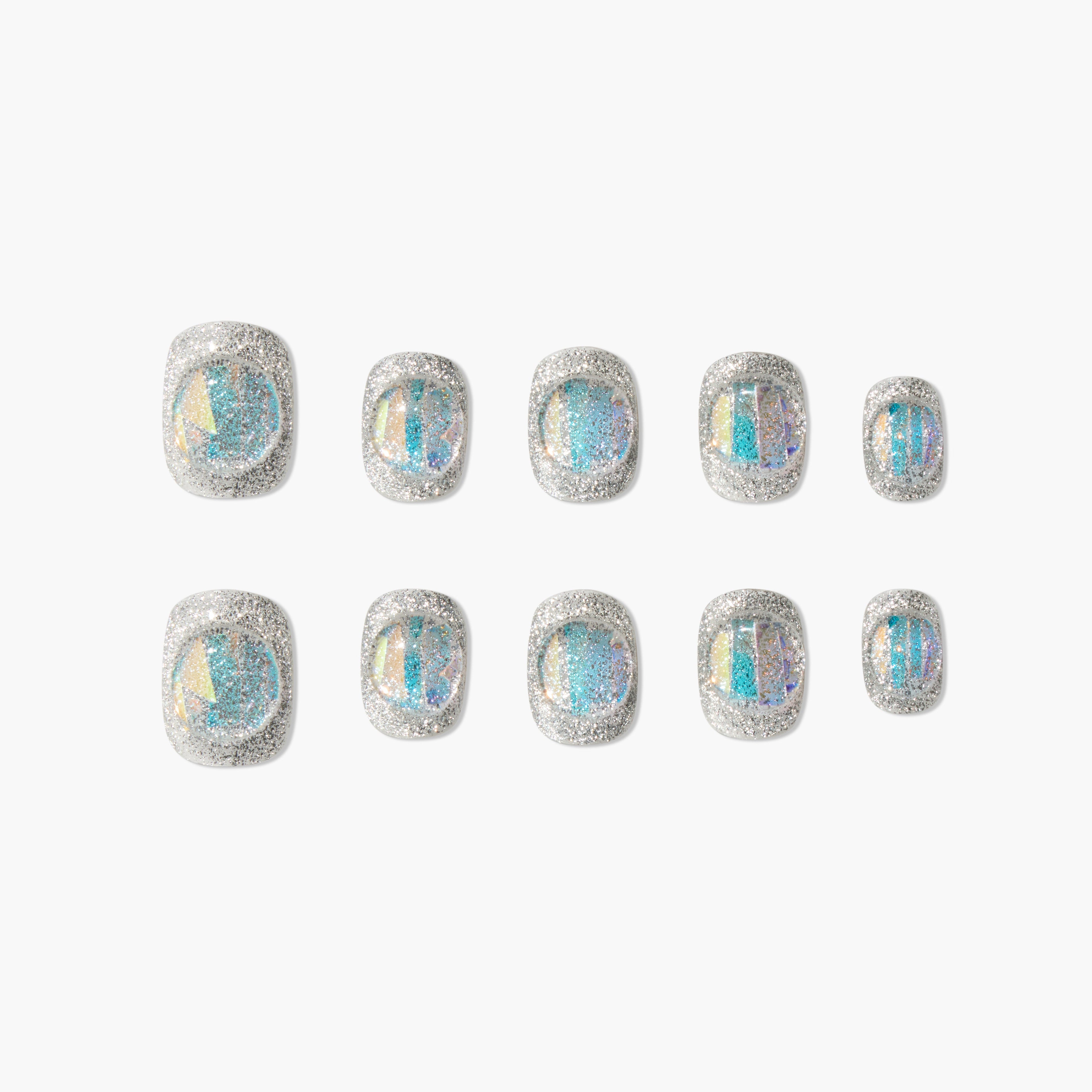 Set of silver glitter press-on nails with iridescent blue accents on a white background