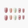 Handmade press-on nails with pink shimmer, heart designs, and pastel gradient accents