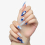 Hand with long almond-shaped press-on nails, blue and white stars and bunny nail art design