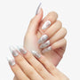 Hand with long almond-shaped silver chrome press-on nails, white background