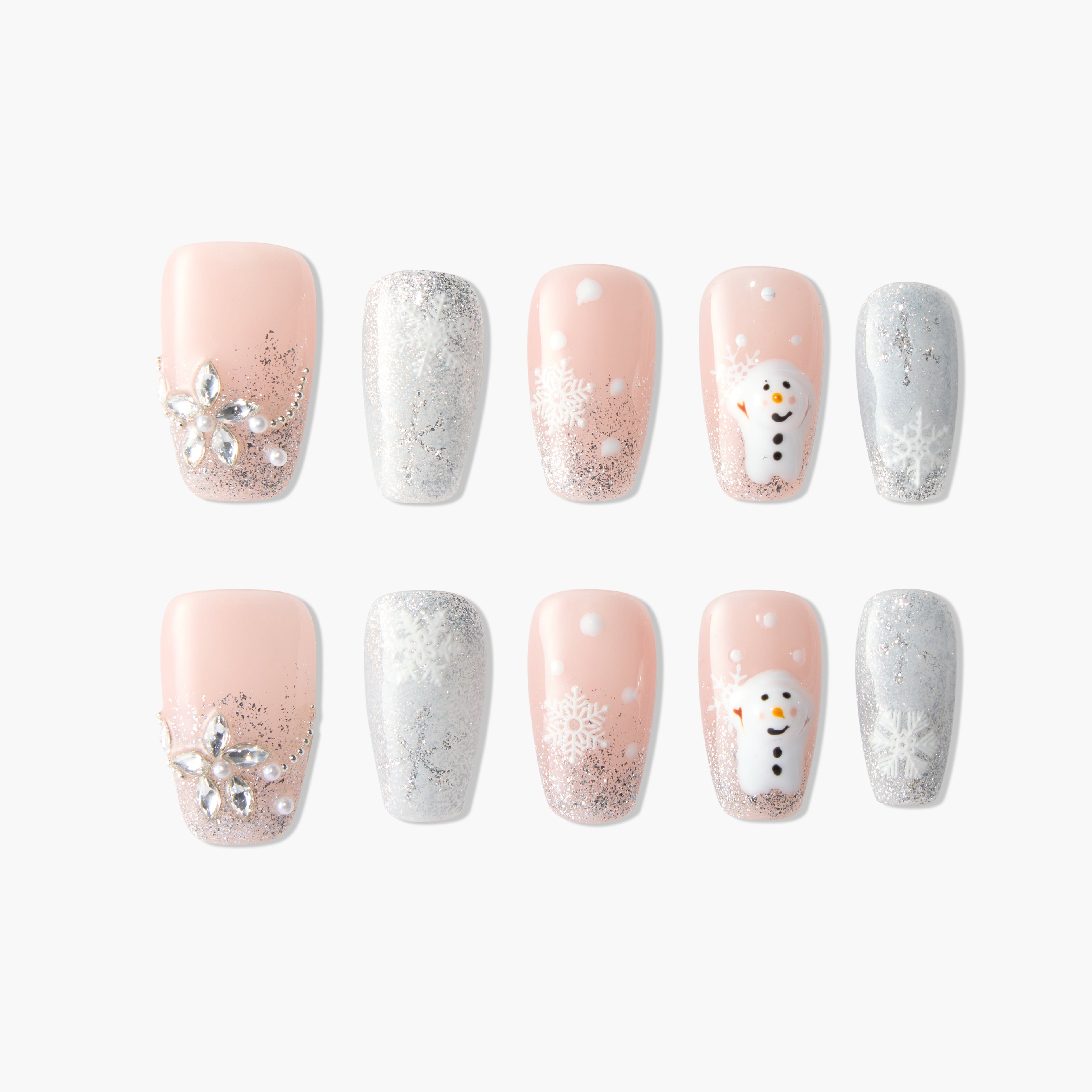 Winter press-on nails with pink, silver glitter, snowflakes, jewels, and snowman designs.