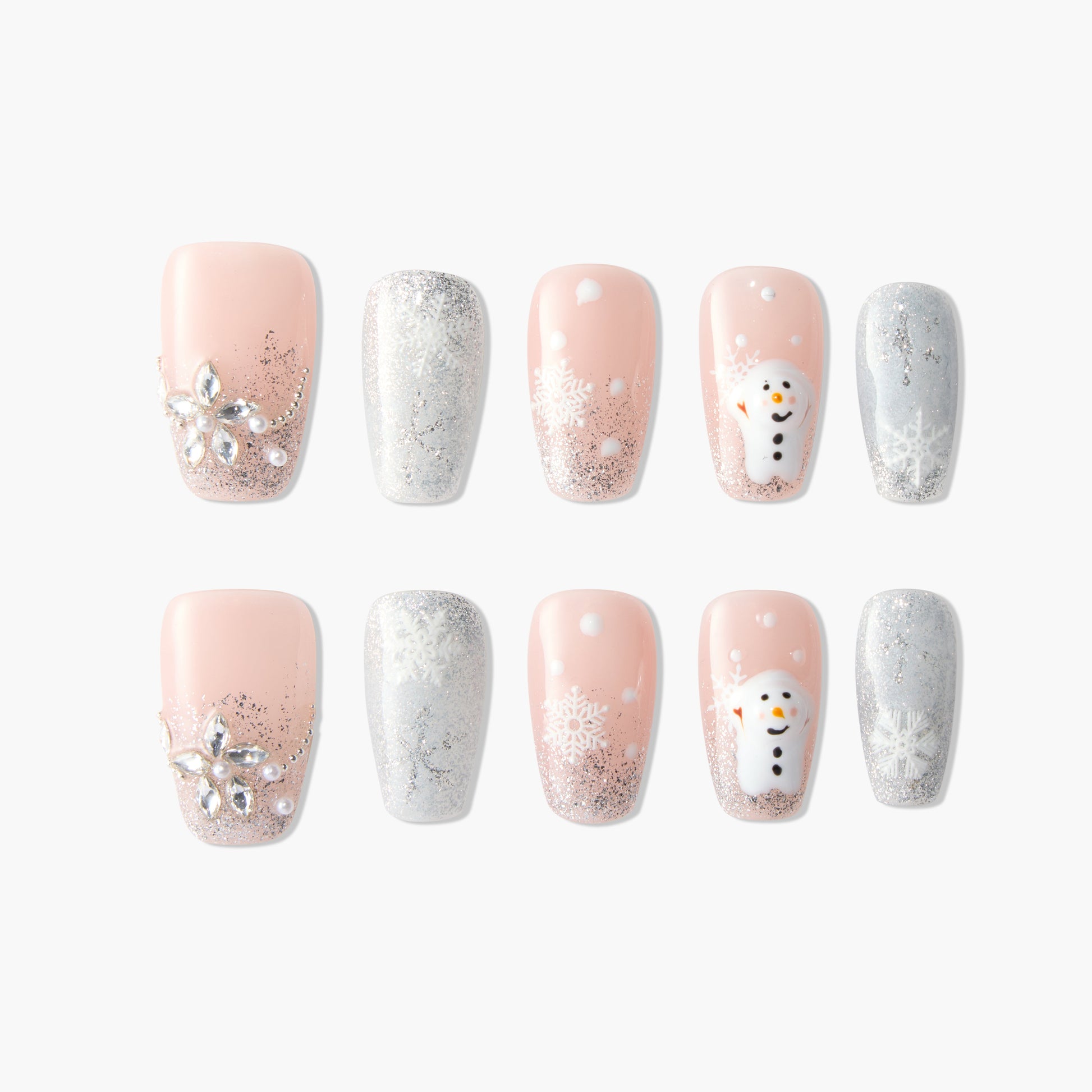 Winter press-on nails with pink, silver glitter, snowflakes, jewels, and snowman designs.