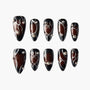 Glossy brown and black press-on nails with silver lines and 3D bead accents, set of ten