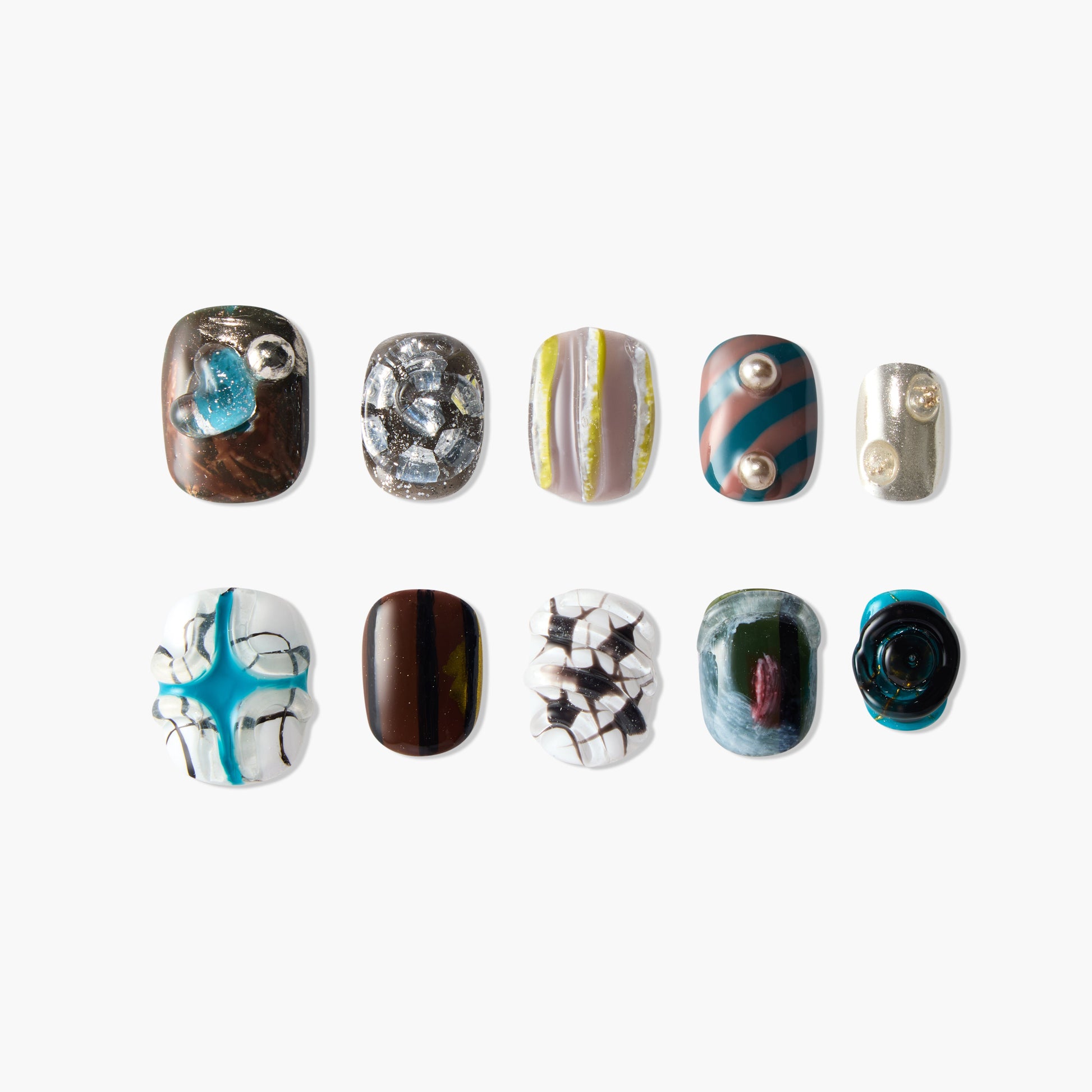 Handmade press-on nails with unique abstract, pearl, and gemstone designs on a white background