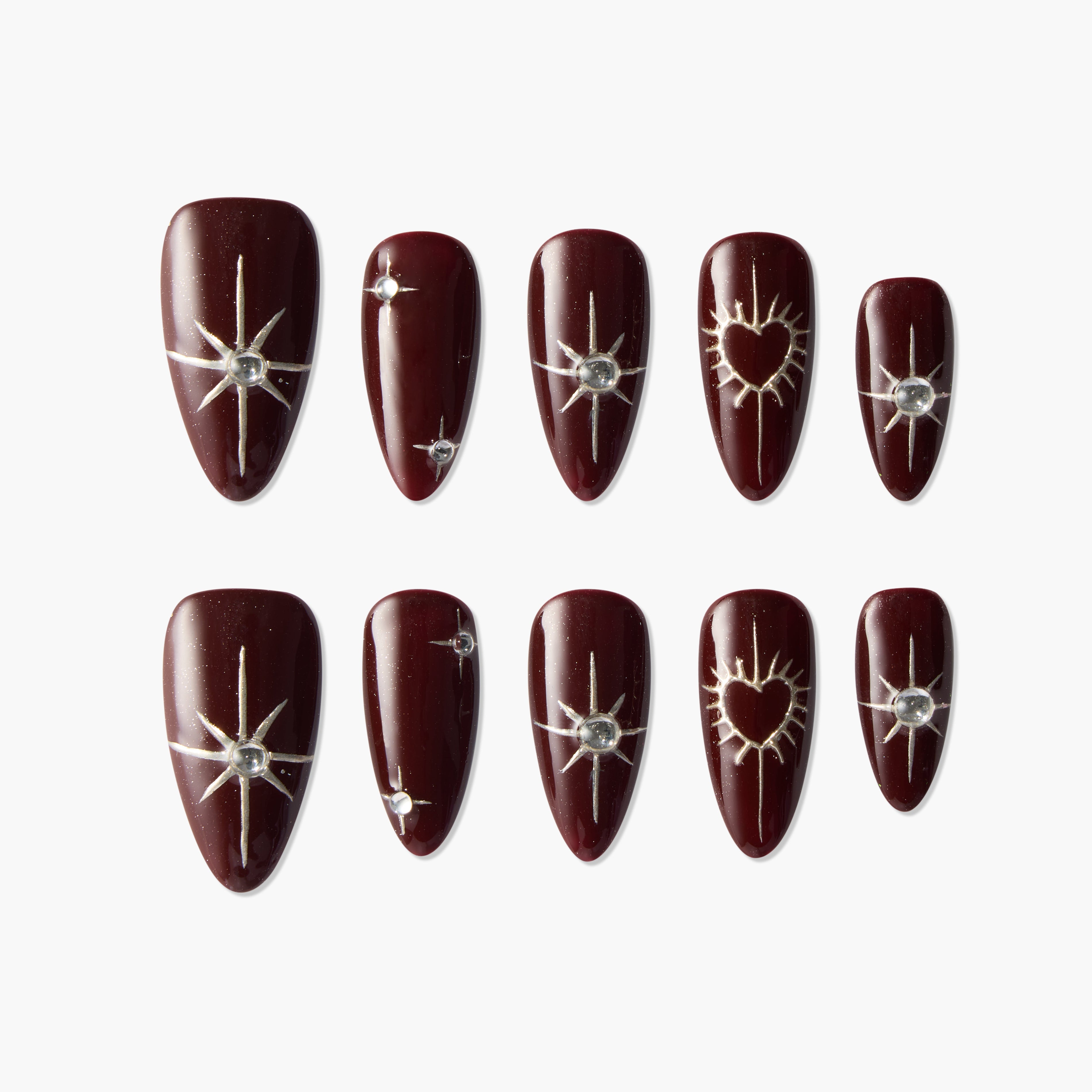 Burgundy press-on nails with silver star and heart designs, rhinestone accents, on white background