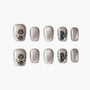 Glittery silver press-on nails with 3D black rose floral accents, reusable and handmade.