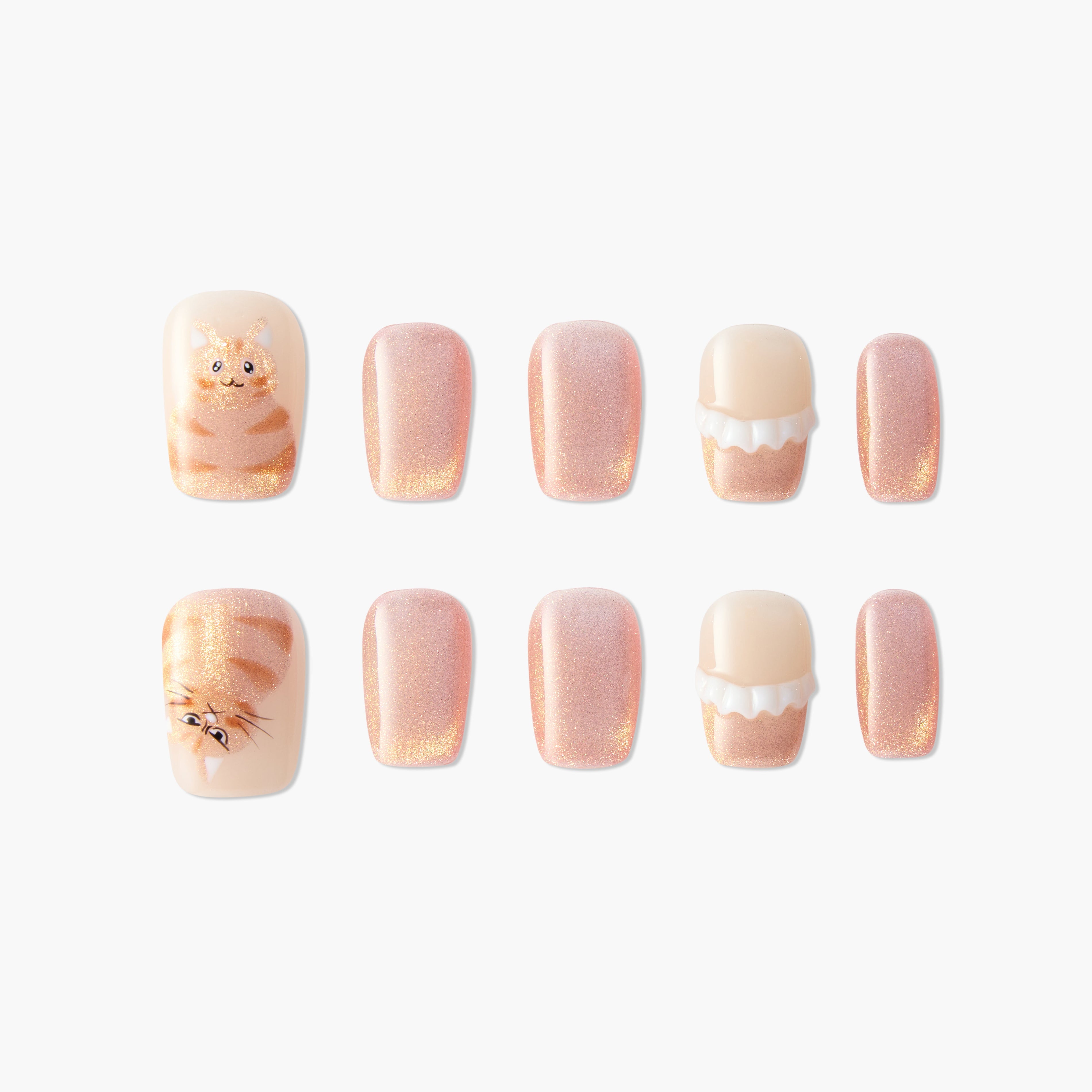 Handmade press-on nails with glittery peach tones, cat art, and dessert-inspired designs