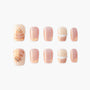 Handmade press-on nails with glittery peach tones, cat art, and dessert-inspired designs