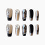 Black and glitter press-on nails with rose designs, rhinestone and chain accents, coffin shape