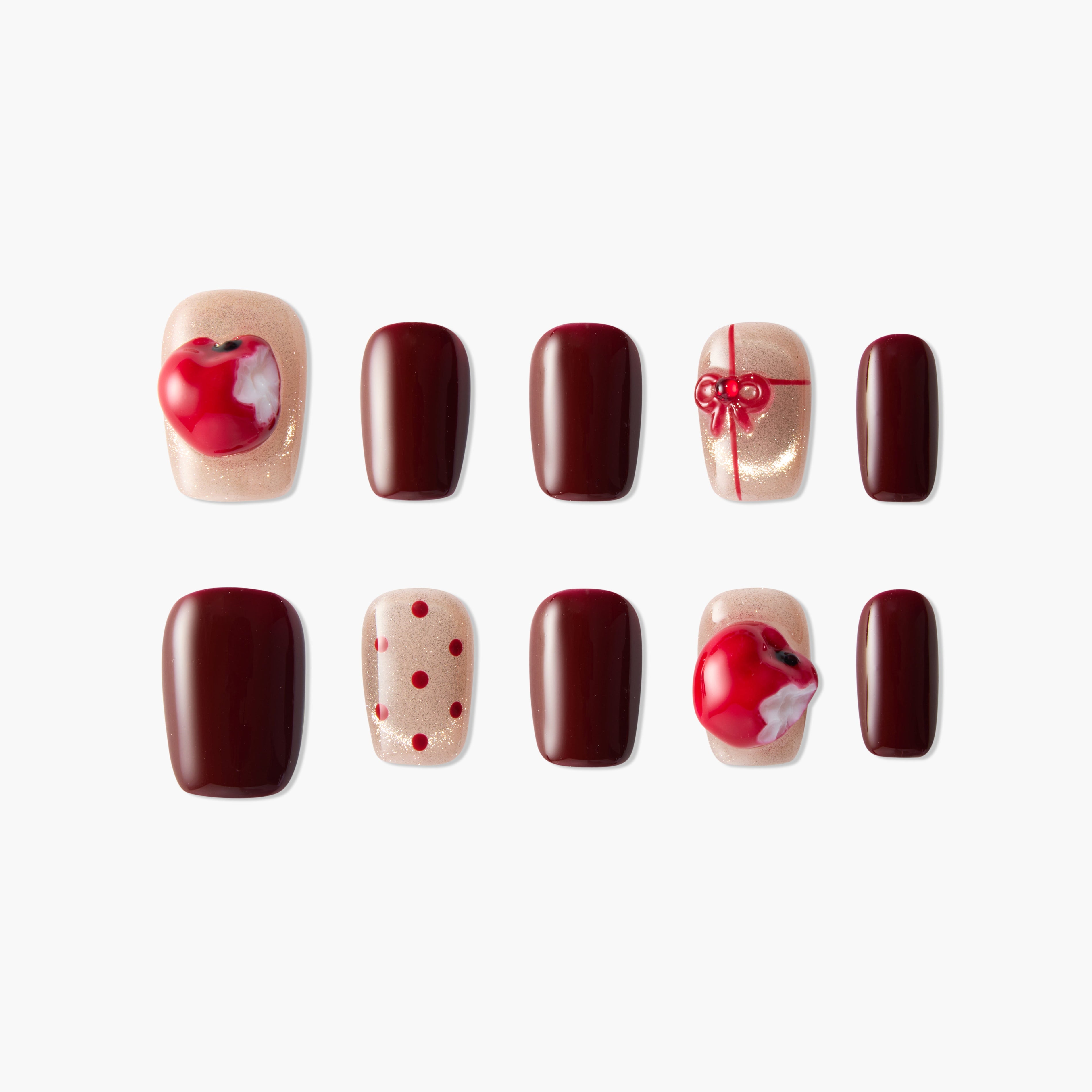 Handmade press-on nails set with red apple, burgundy, and gold designs, dot and bow details.