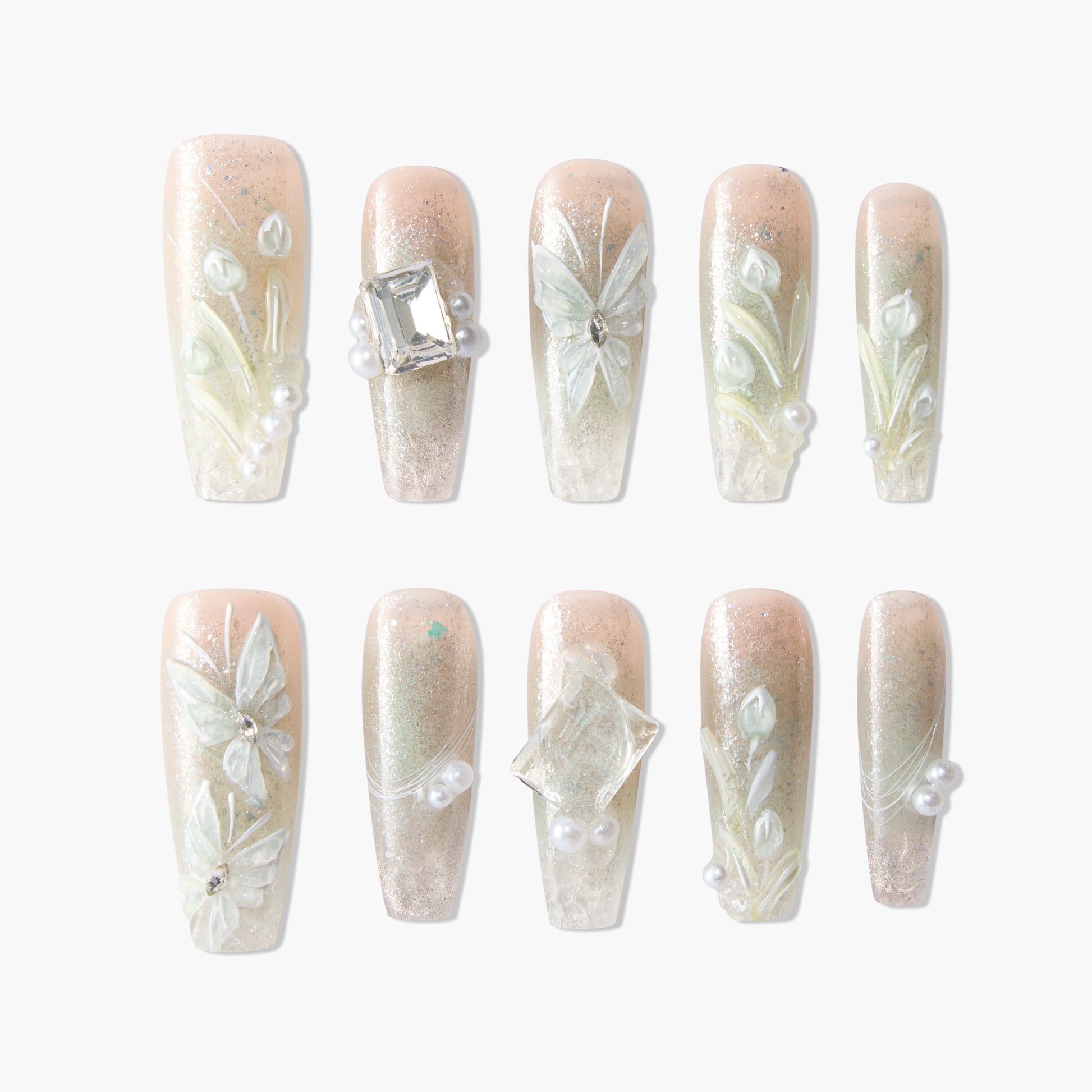 Handmade press-on nails with 3D white floral designs, pearls, crystals, and nude glitter base.