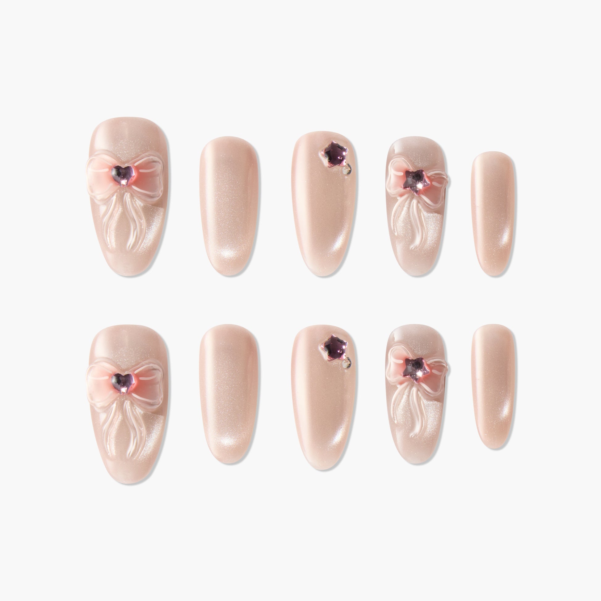 Handmade nude press-on nails with pink 3D bows and gemstone accents