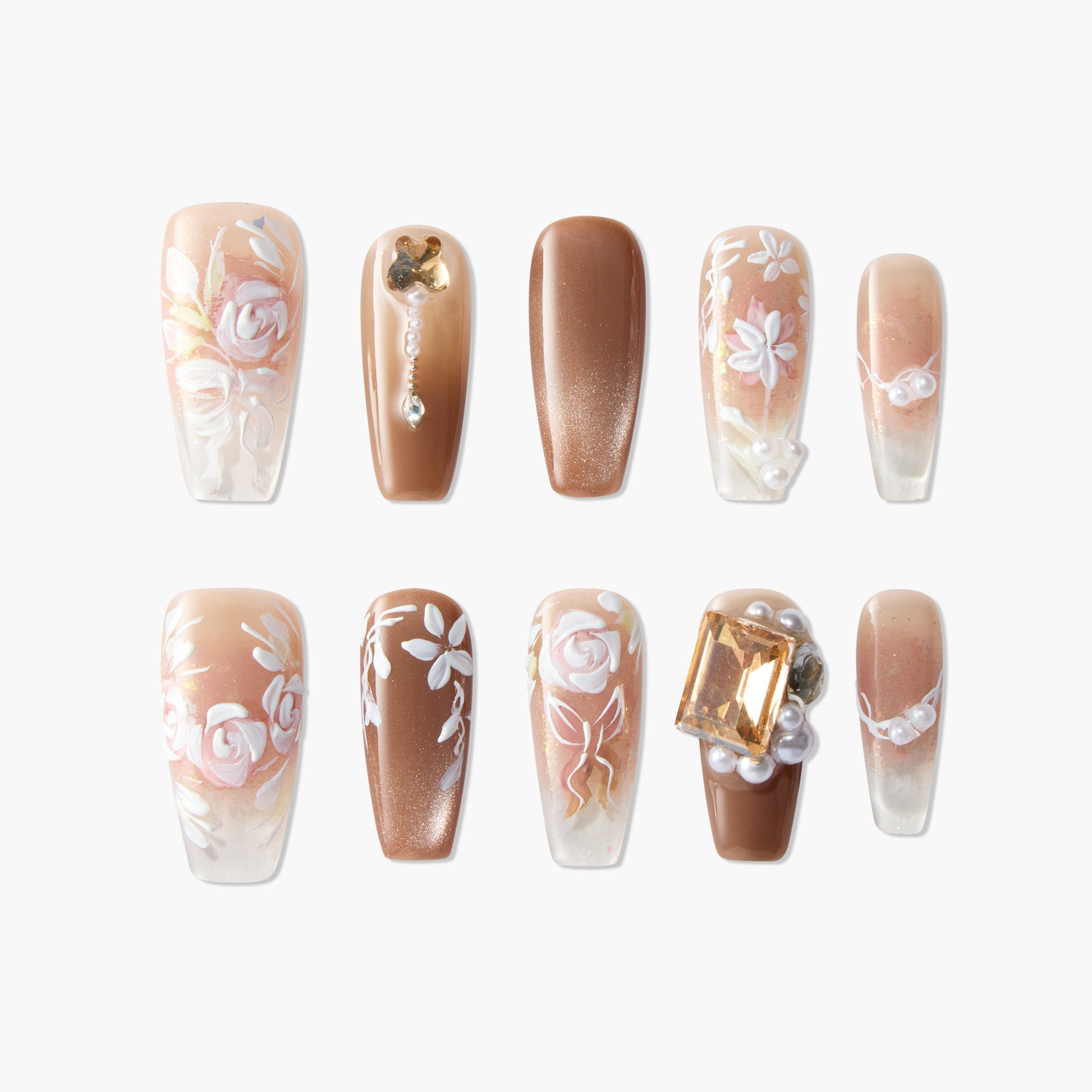 Handmade press-on nails with brown tones, floral designs, pearls, and gemstone accents.