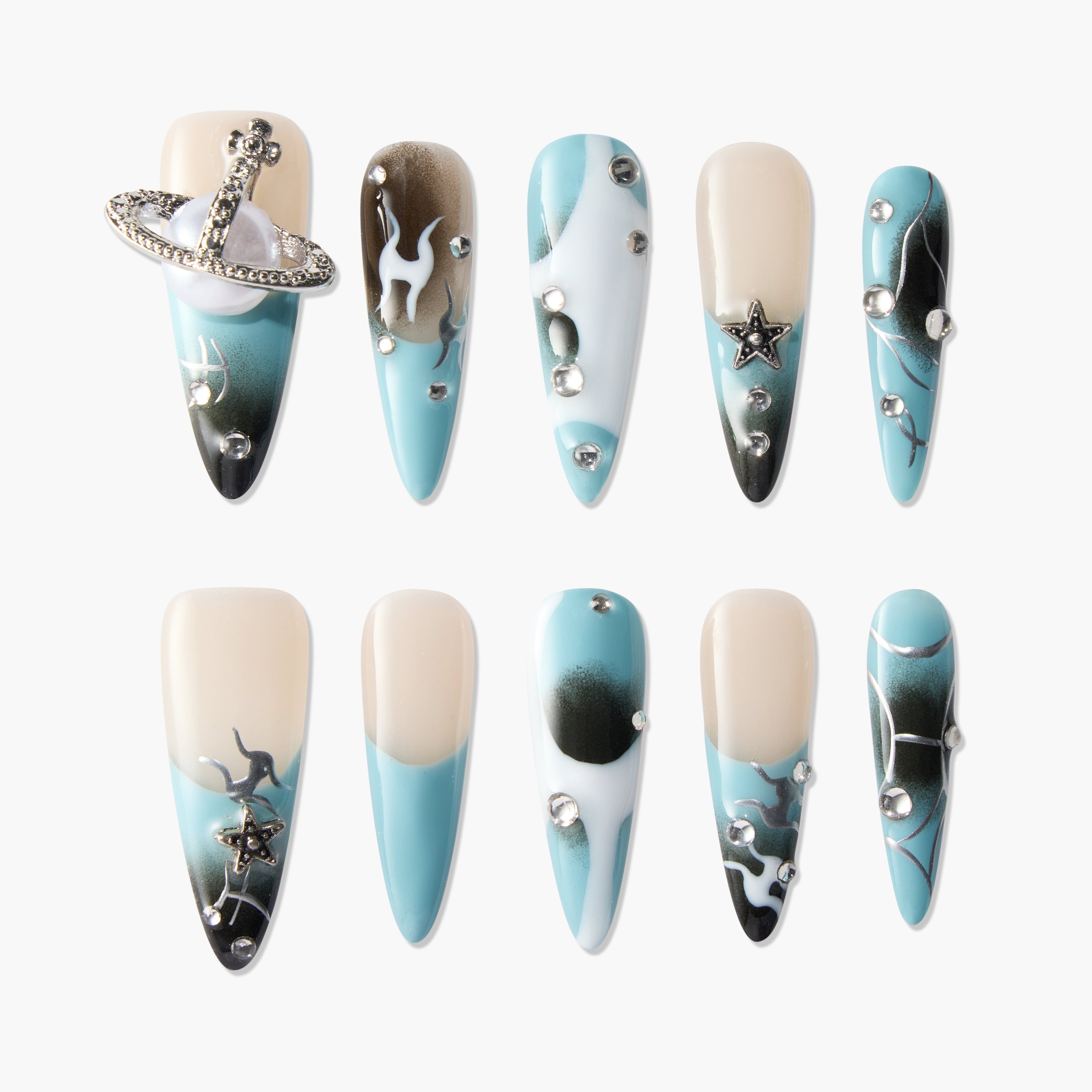 Blue and nude almond-shaped press-on nails with silver star charms, rhinestones, and abstract designs.