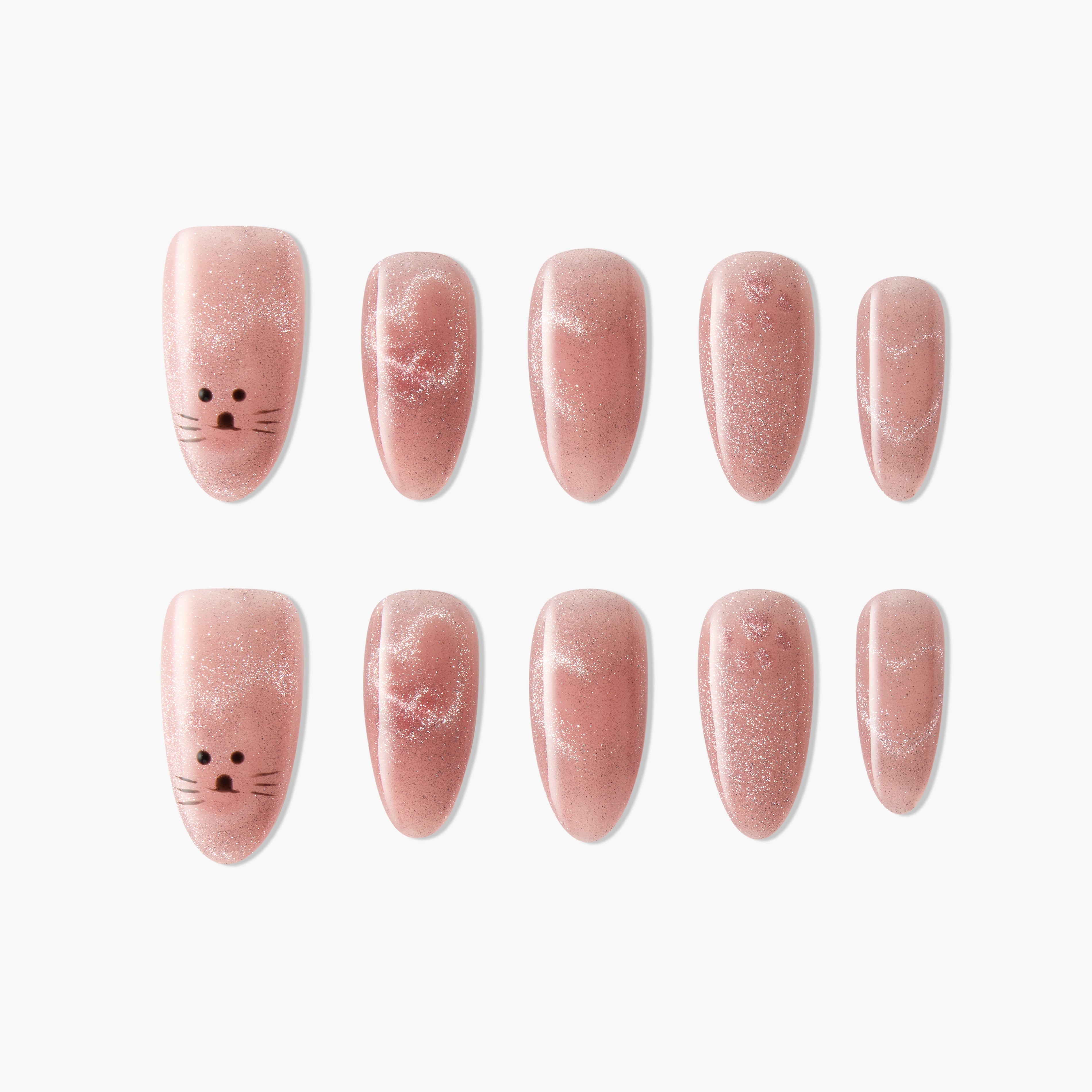 Handmade pink press-on nails with glitter and cute cat face design, arranged on white background.