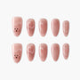 Handmade pink press-on nails with glitter and cute cat face design, arranged on white background.