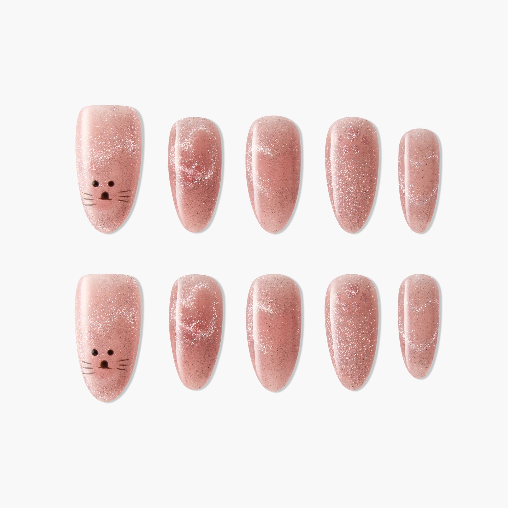 Handmade pink press-on nails with glitter and cute cat face design, arranged on white background.