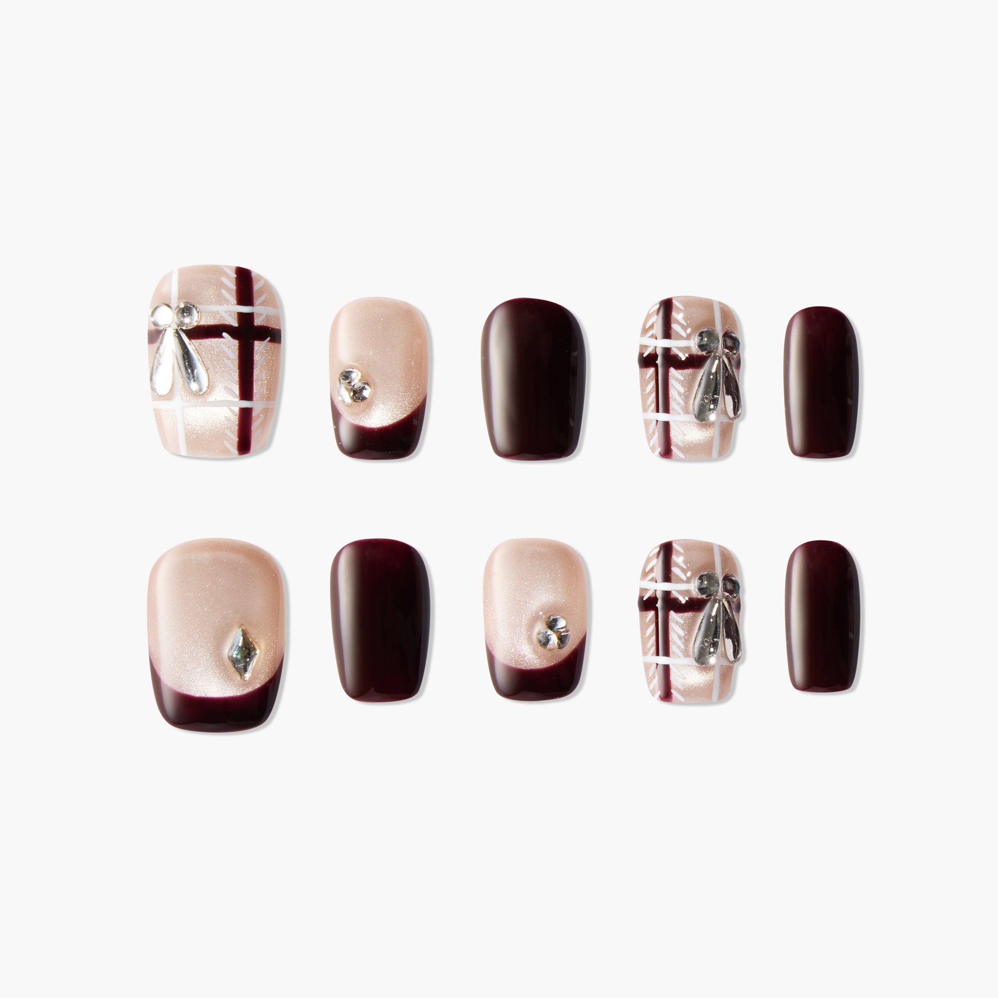 Glossy press-on nails with burgundy and nude plaid design, rhinestone and ribbon accents