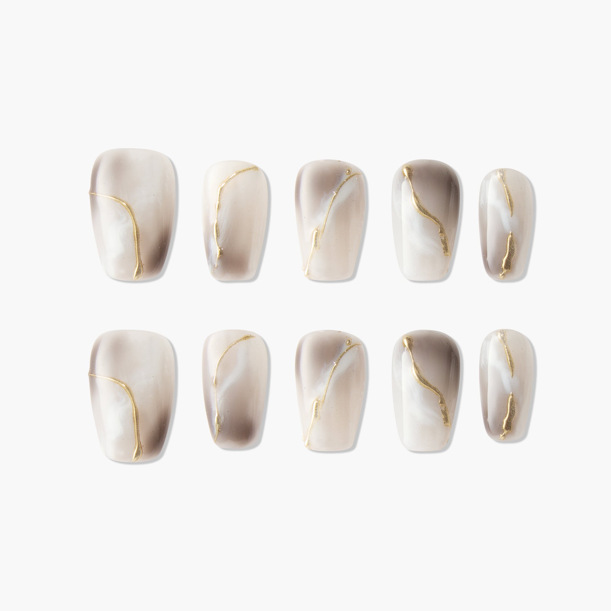 Handmade press-on nails with marble beige and gold accent design, salon-quality finish