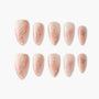 Handmade press-on nails with nude base, floral and butterfly designs, and gold glitter accents.