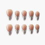 Glossy nude press-on nails with silver chrome tips and rhinestone accents, arranged in rows.