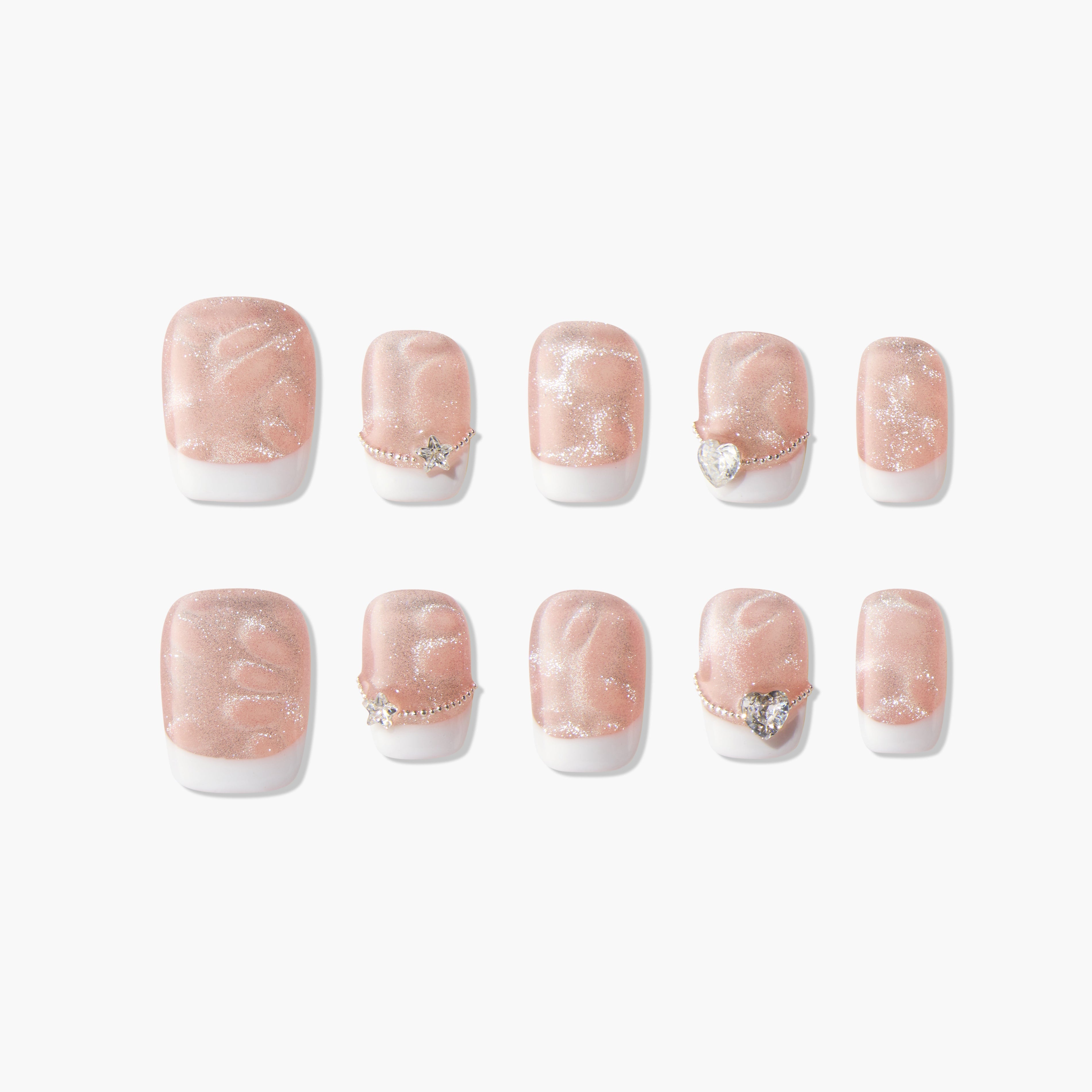 Set of pink glitter press-on nails with white tips and gemstone accents, displayed on white background.